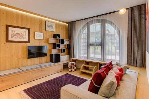 a living room with a couch and a tv at Apartment Chéserys, Alpes Travel, Les Praz Sleeps 2-4 in Chamonix-Mont-Blanc