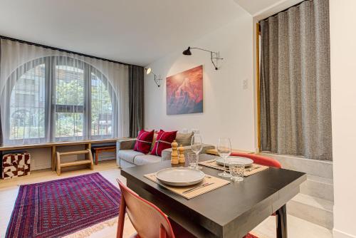 a living room with a table and a couch at Apartment Chéserys, Alpes Travel, Les Praz Sleeps 2-4 in Chamonix-Mont-Blanc