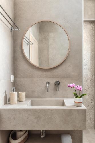 a bathroom with a sink and a mirror at Ierapetra’s Mosque House in Ierapetra