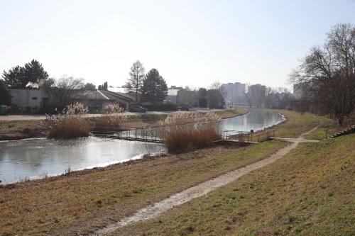 a river with a bridge in a field at Sunny House Two in Bratislava