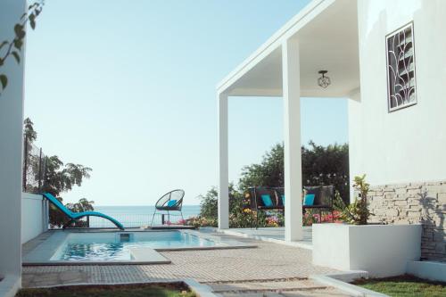 a swimming pool with a view of the ocean from a house at RESIDENCE SAPHIR in Mahajanga