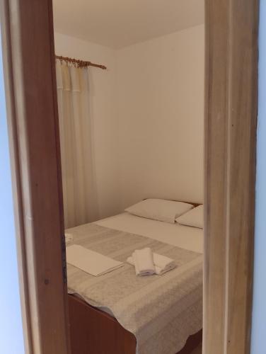 a bedroom with a bed with a towel on it at Apartments Mustel Drage - Adults Only in Drage