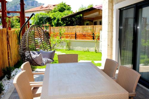 een eettafel en stoelen op een patio bij Villa Bianca in Dalyan