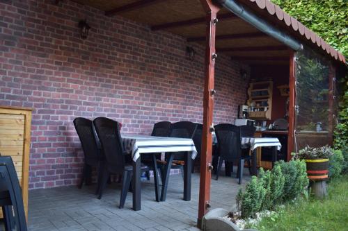 a patio with a table and chairs under a brick wall at Casa Mara in Tulcea