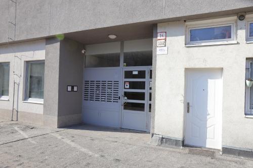 a building with a blue door in front of it at Sunny House Two in Bratislava