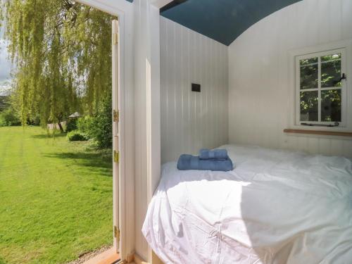 um quarto com uma cama e uma grande janela em The Hares Rest em Shipston on Stour