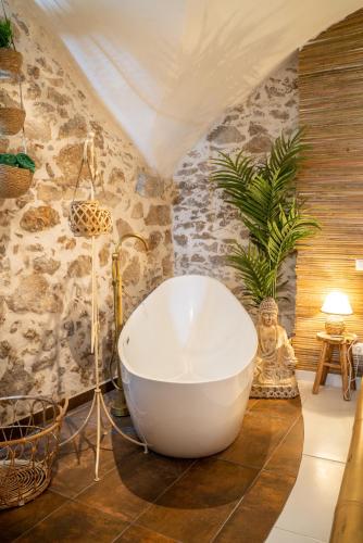 a bathroom with a large white tub in a room at Le Bali Safranier Vieil Antibes in Antibes