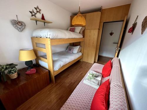 a room with two bunk beds and a couch at Casa Horvais San Candido in San Candido