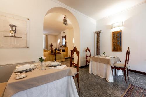 a dining room with two tables and a sink at La Casa nel Borgo in Piadena