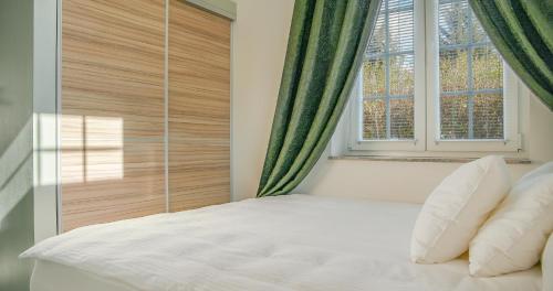 a bedroom with a white bed and a window at Open Space in Varaždin