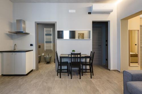 a kitchen and dining room with a table and chairs at Room Don Alfonso Luxury in Parma