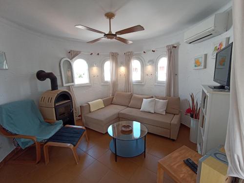 a living room with a couch and a table at Casa Joana in Cala Santanyi