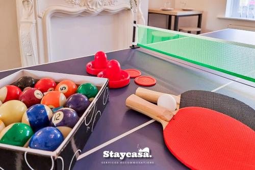 a ping pong table with balls at Modern Comforts In Ne Lincolnshire Entire Home in Grimsby