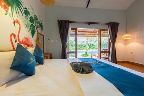 a bedroom with a large bed with a towel on it at Khu Nghỉ Dưỡng Green Bungalow Phu Quoc in Phu Quoc