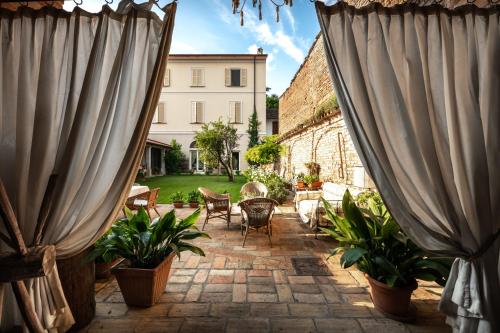 a patio with two large curtains and plants at La Casa nel Borgo in Piadena