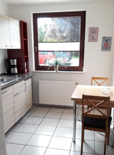 a kitchen with a table and a window at Ferienwohnung Roeben in Simmerath