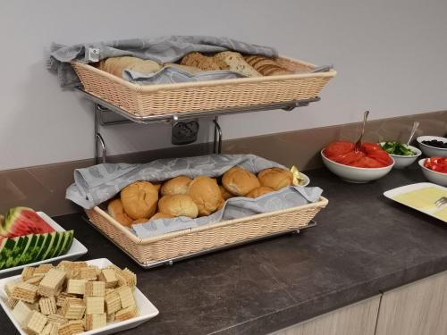 a table with baskets of bread and other foods at Pensjonat Złoto Bałtyku in Łeba