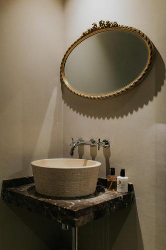 a bathroom with a sink and a mirror at Newton Hall in Chathill