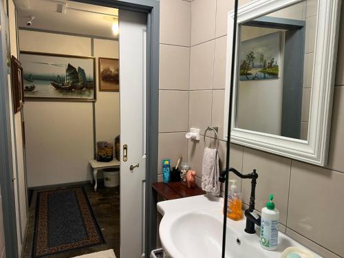 a bathroom with a sink and a mirror at XYL Holiday Inn in Caloundra