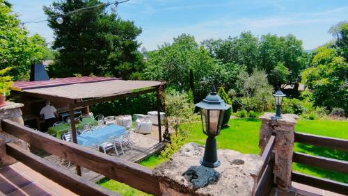 a garden with a table and a gazebo at El huerto de la Reina in Becerril de la Sierra