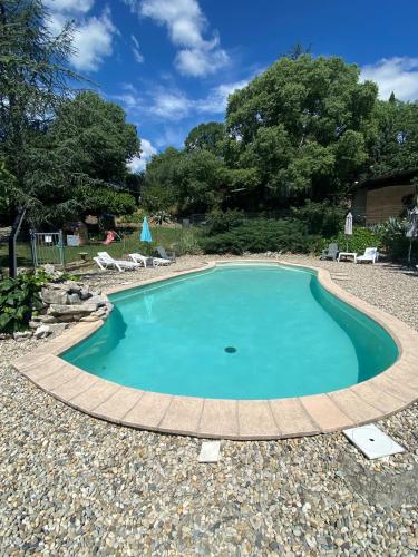 a small pool with a boardwalk around it at Chambres d'hôtes les Clapas in Chauzon