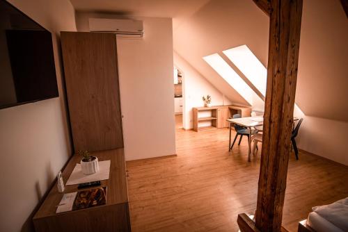 a living room with a table and a skylight at Penzion Panský dvůr Telč in Telč