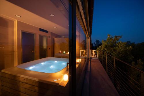 a bath tub on the balcony of a house at Relais Casa Clara in Monteu Roero