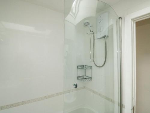 a shower with a glass door in a bathroom at Sunny Breeze in Kingsbridge