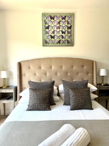 a bedroom with a large white bed with pillows at Beautiful Beach House in Littlestone-on-Sea