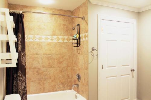 a bathroom with a shower and a bath tub at Private bedrooms+free parking in Lower Sackville