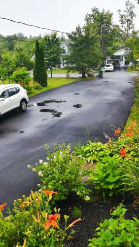 a parking lot with a car parked in a driveway at Private bedrooms+free parking in Lower Sackville