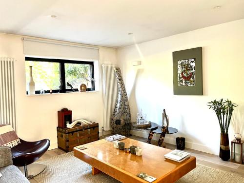 a living room with a coffee table and a window at Beautiful Beach House in Littlestone-on-Sea