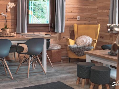 a dining room with chairs and a table and a table and a tableablish at Drevenice Wars & Sawa in Oščadnica