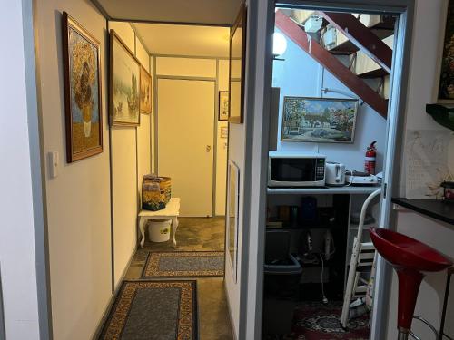 a hallway leading to a kitchen with a stairway leading into a room at XYL Holiday Inn in Caloundra