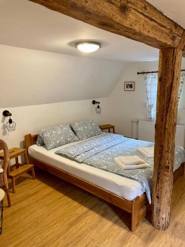 a bedroom with a bed with a wooden frame at Pension Soutěsky in Hřensko