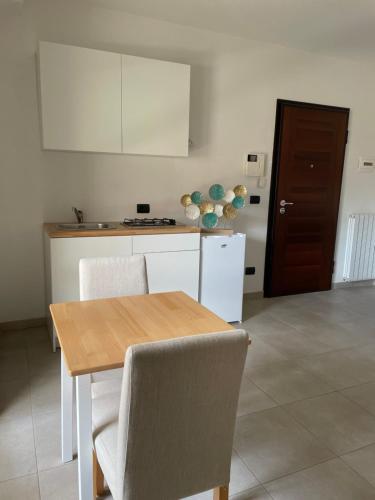 a kitchen with a wooden table and a table and chairs at In centro in Avezzano