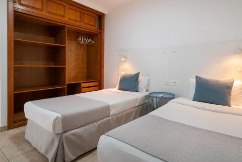 two beds in a hotel room with two at Sabbia Suites Sea View La Playita in Puerto del Carmen