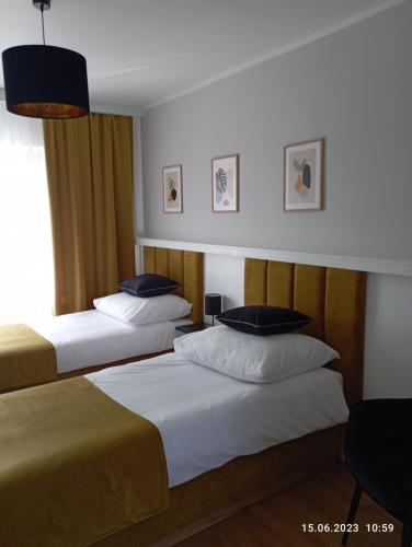 a hotel room with two beds and a window at STUDIO 102 in Bachowice