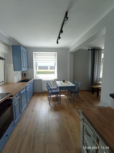 a large kitchen with a table and chairs in it at STUDIO 102 in Bachowice