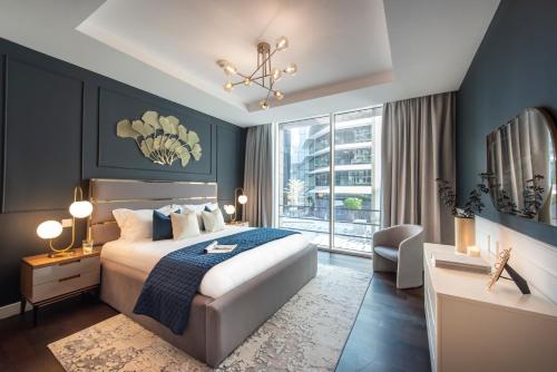a bedroom with a bed and a large window at Nasma Luxury Stays - Limestone House in Dubai