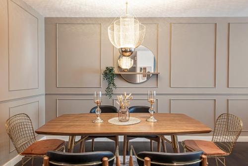 a dining room with a wooden table and chairs at Nasma Luxury Stays - Limestone House in Dubai