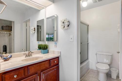 a bathroom with a sink and a toilet and a shower at Princeville Puamana 21A in Princeville