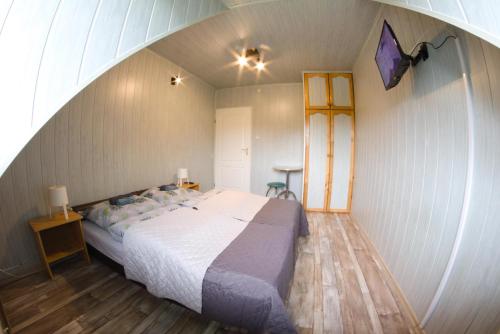 a bedroom with a large bed in an attic at Baza w Bieszczady in Solina