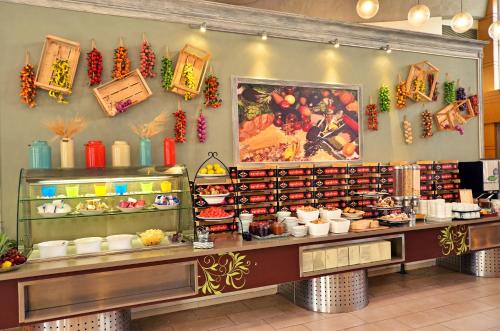 a display case in a restaurant with food on display at Ruth Daniel Residence in Tel Aviv