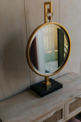 a mirror on top of a wooden table at Newton Hall in Chathill