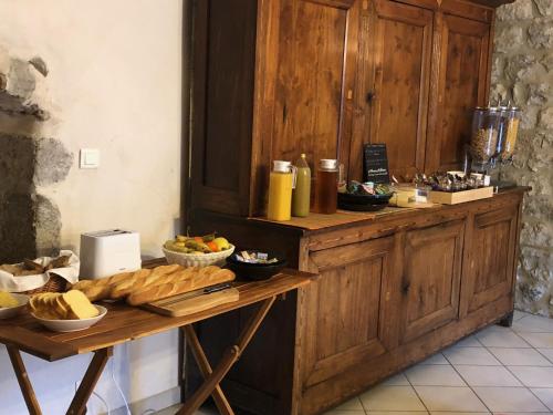 a buffet with bread and other food on a table at Chambres d'hôtes les Clapas in Chauzon