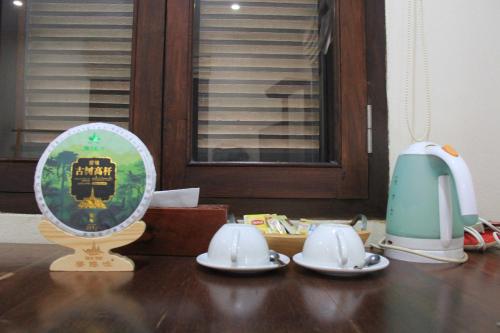 a table with a mirror and plates on a table at Ancient Luangprabang Hotel in Luang Prabang