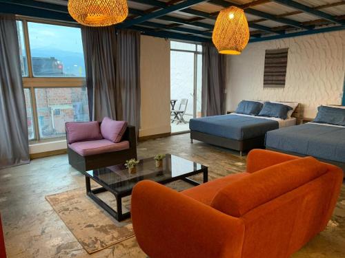 a living room with a couch and a table at Hotel Casa Lucca in Medellín