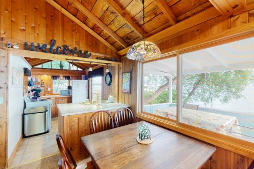 a kitchen and dining room with a table and a window at Sweet Sunrise in Penn Yan