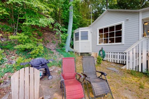 a group of chairs in a yard next to a house at Sweet Sunrise in Penn Yan